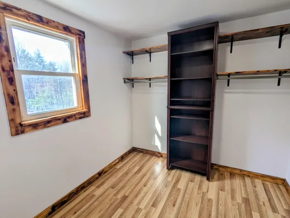 a room with pool table windows and wooden floor