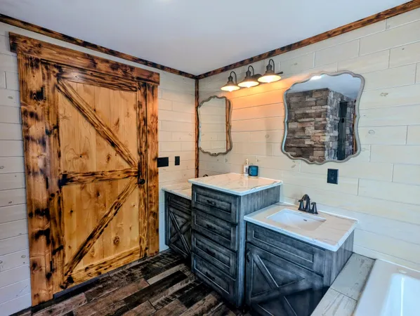 a view of a room with wooden floor and a window