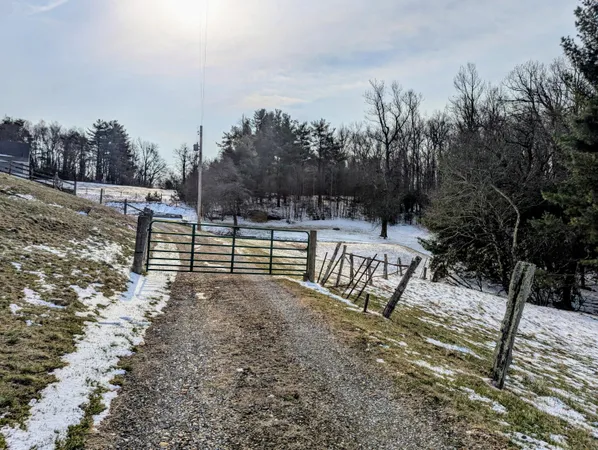 a view of a yard with wooden fence