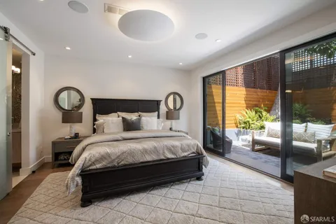 a bed room with a bed and a large window