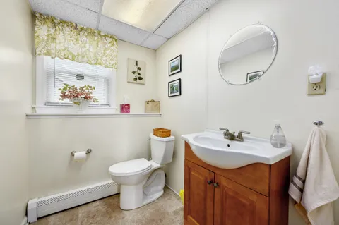 a bathroom with a sink mirror and toilet