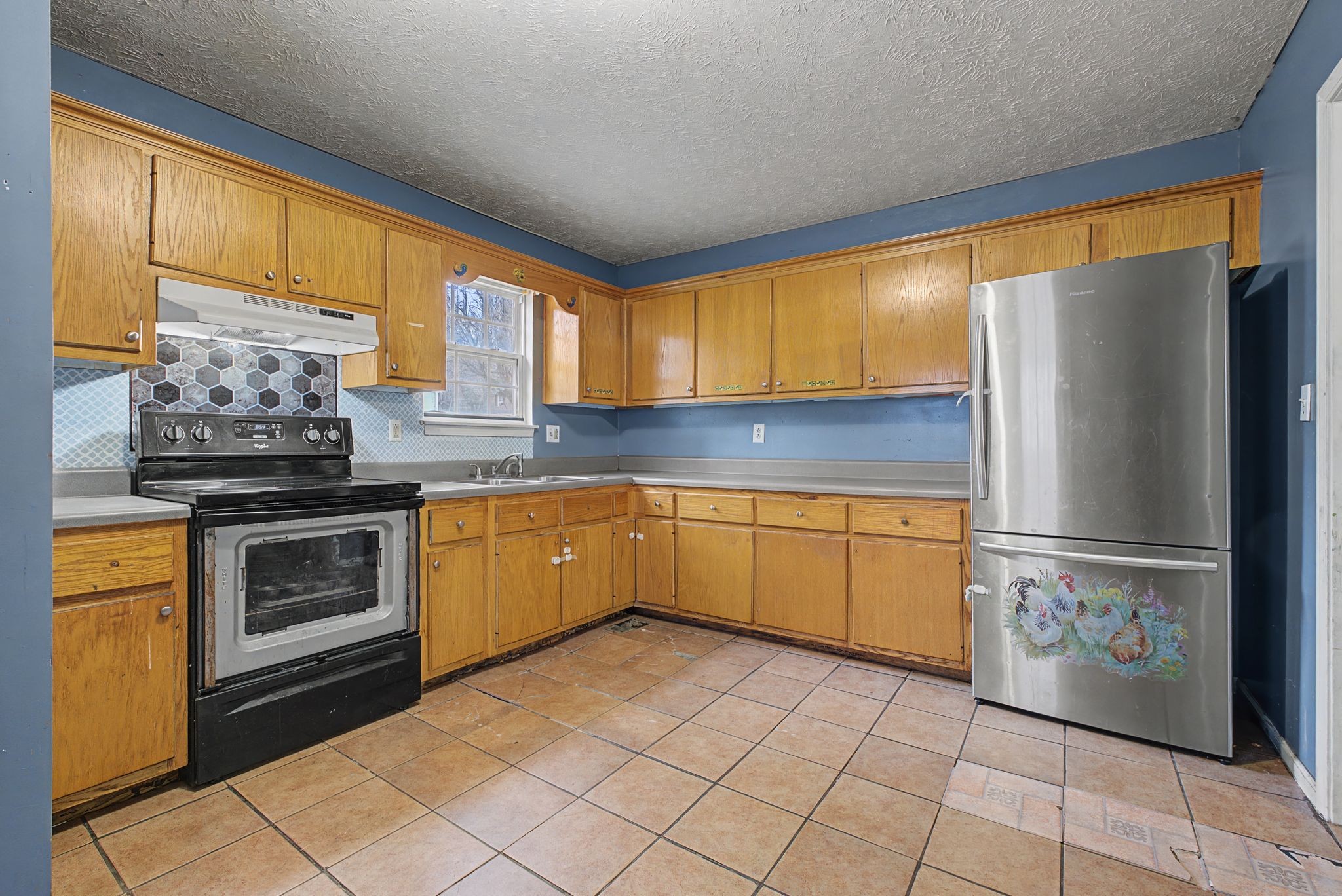 178 Spring Street Carthage, TN 37030 - Photo 8 of 27 a kitchen with stainless steel appliances granite countertop a refrigerator a sink dishwasher a stove with granite countertops and cabinets