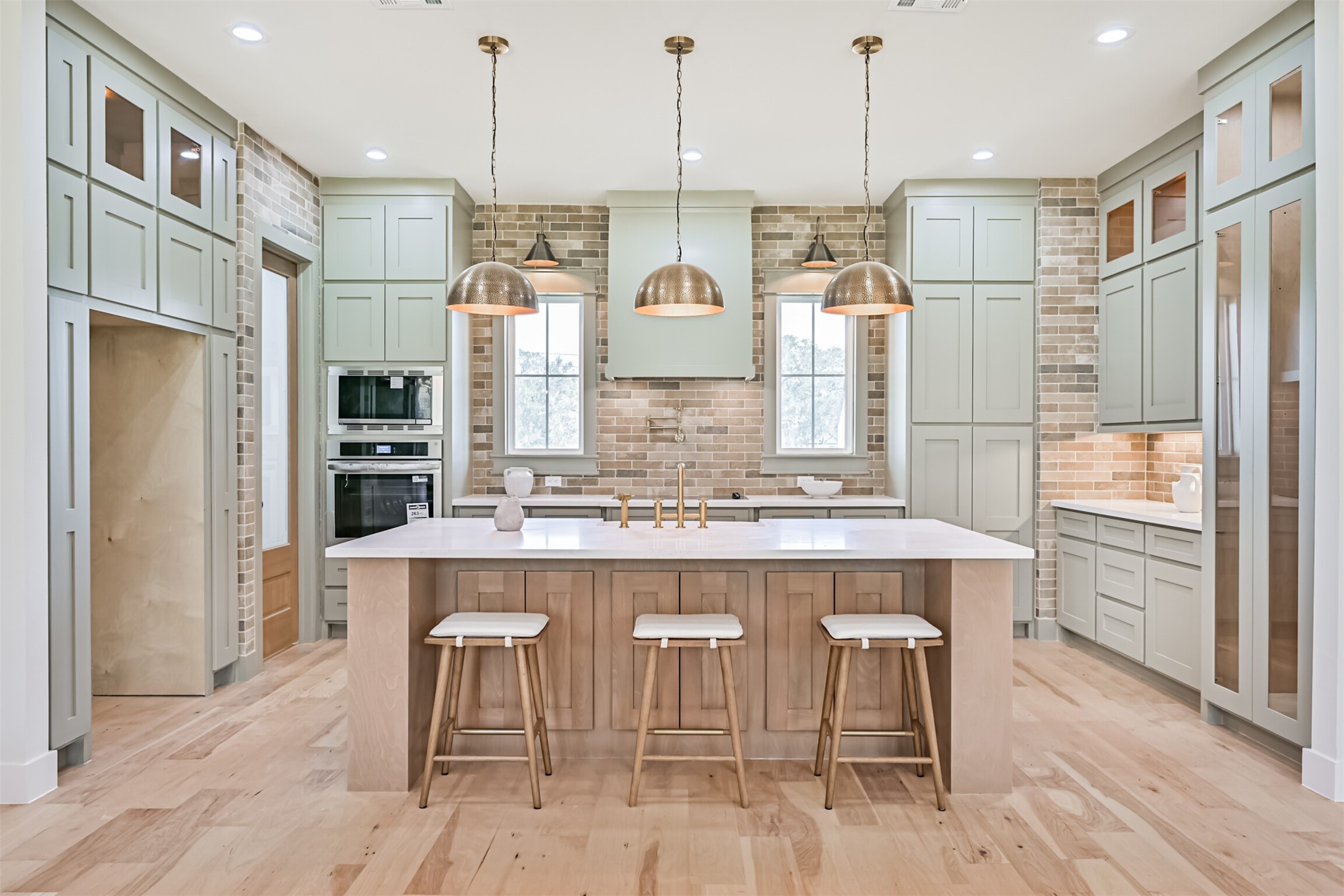 208 Pony Trail Angleton, TX 77515 - Photo 12 of 50 a kitchen with kitchen island a breakfast area and windows