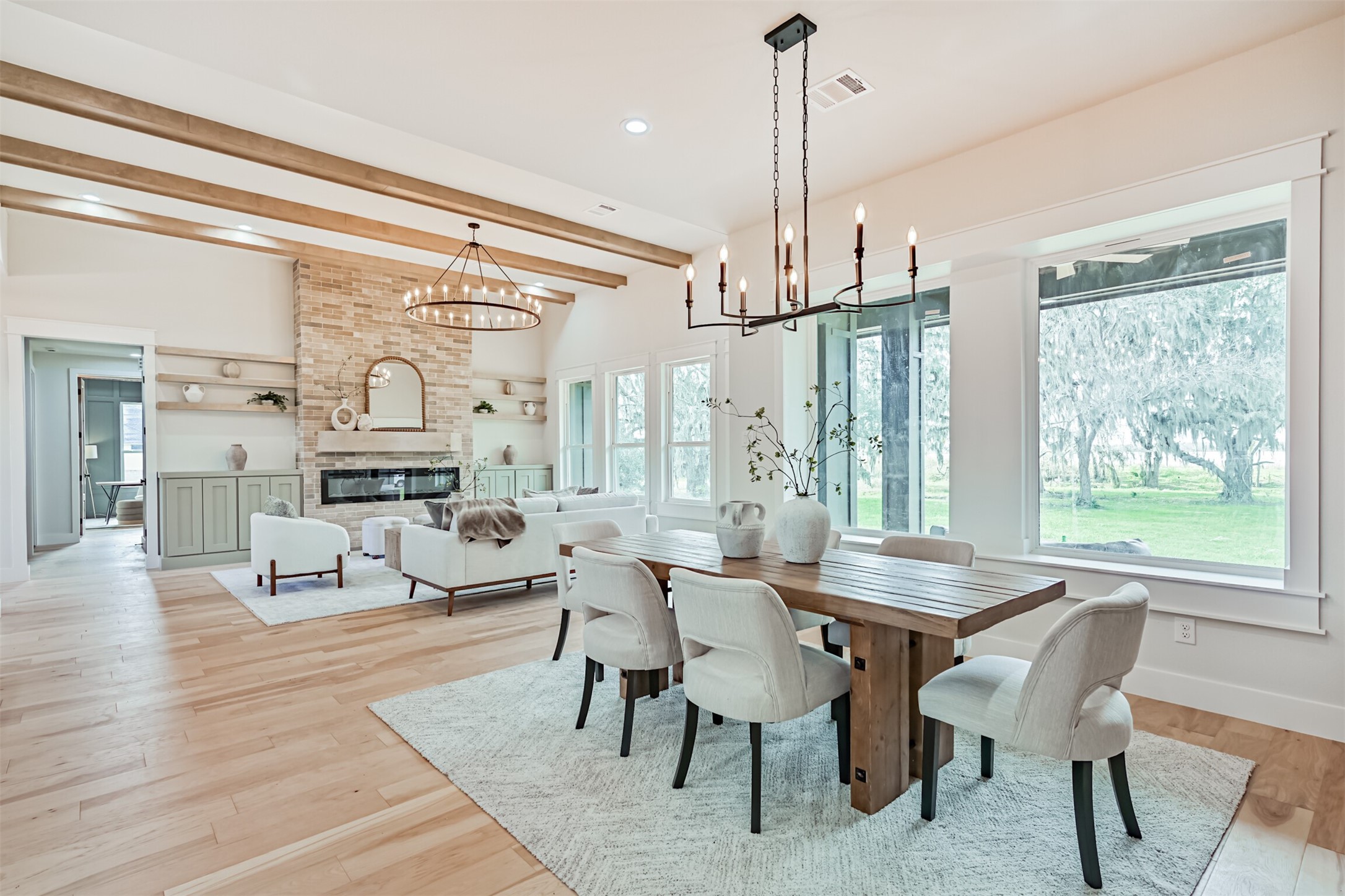 208 Pony Trail Angleton, TX 77515 - Photo 24 of 50 a view of a dining room and livingroom with furniture wooden floor a chandelier