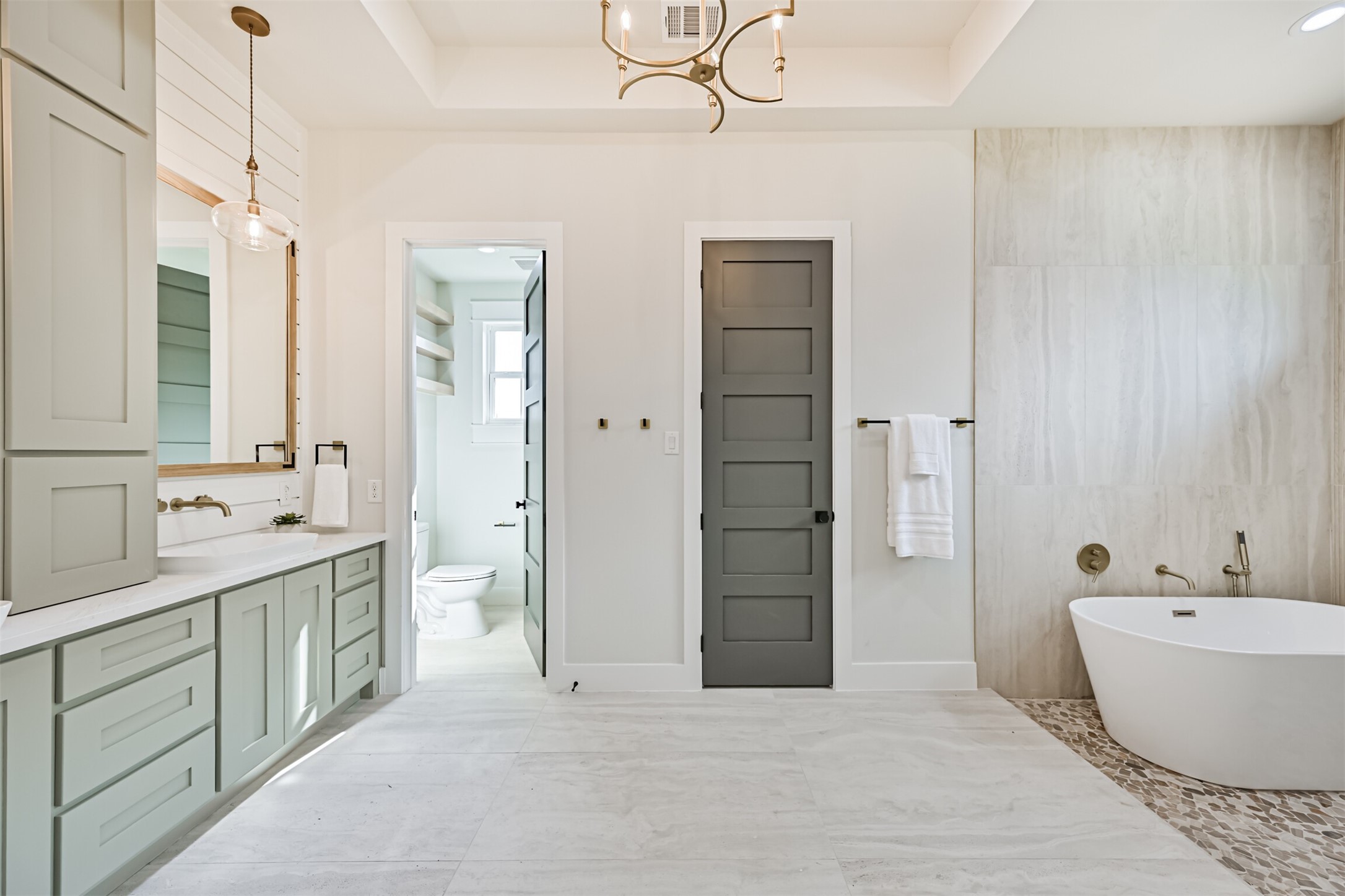 208 Pony Trail Angleton, TX 77515 - Photo 32 of 50 a spacious bathroom with a double vanity sink a mirror and a bathtub
