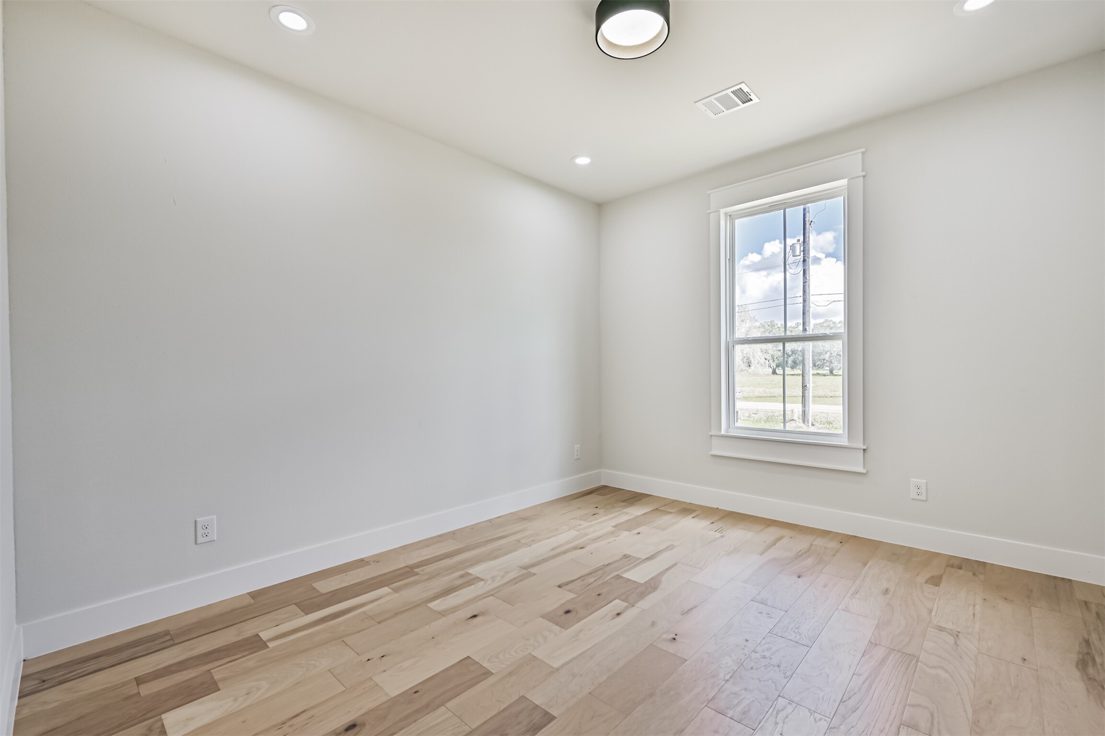 208 Pony Trail Angleton, TX 77515 - Photo 44 of 50 wooden floor in an empty room with a window