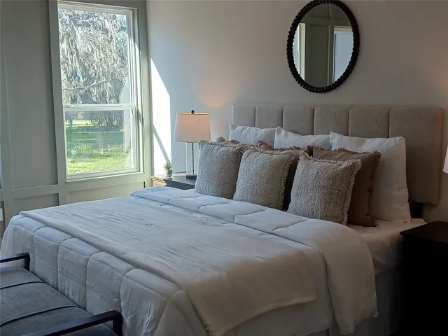 a bedroom with a bed and a mirror