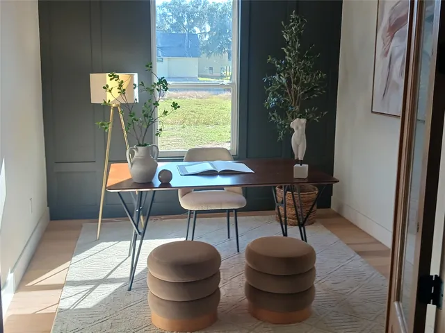 a living room with furniture and a potted plant