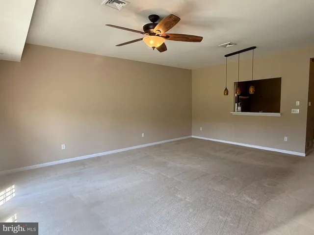 a view of room with flat screen tv and ceiling fan