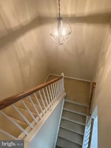 an empty room with a ceiling fan and carpet