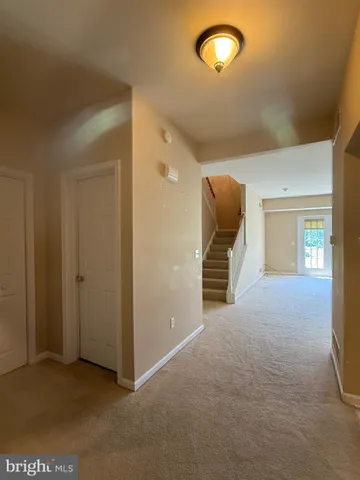 a view of a livingroom with furniture and staircase