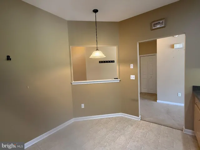 a view of a kitchen with a sink and a cabinet