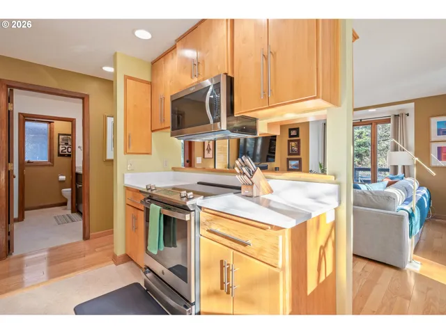 a kitchen with stainless steel appliances kitchen island granite countertop a sink and a stove