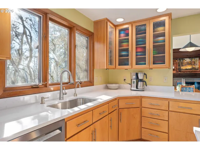 a kitchen with stainless steel appliances granite countertop a sink and a window