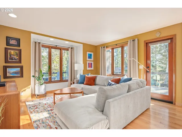 a living room with furniture and large windows