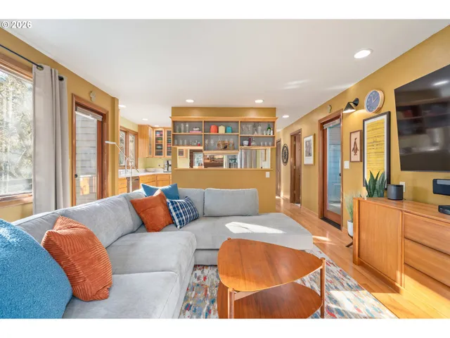 a bedroom with furniture and a large window