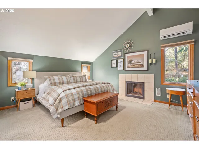 a spacious bedroom with a bed and a fireplace