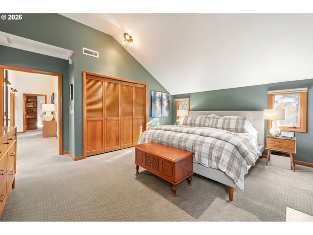 a spacious bedroom with a bed and large cabinets