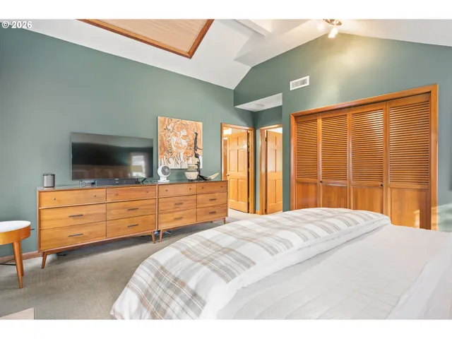 a bedroom with a bed and a dresser