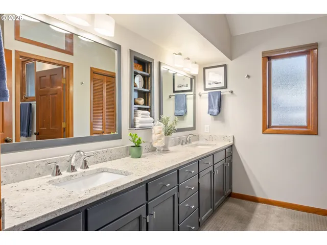 a bathroom with a granite countertop sink mirror and double