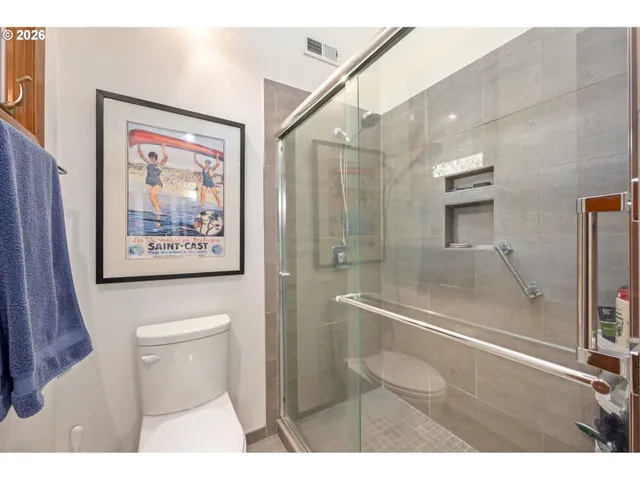 a bathroom with a shower and a toilet