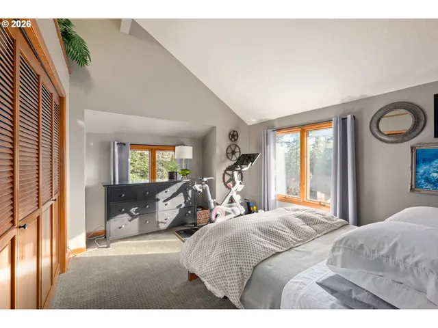 a bedroom with a large bed and a large window