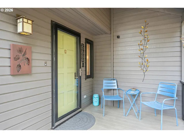 a balcony with table and chairs