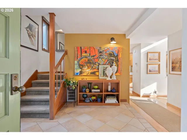 a living room with furniture and a painting on the wall