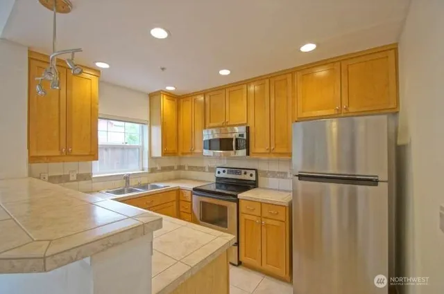 a kitchen with wooden cabinets and white appliances
