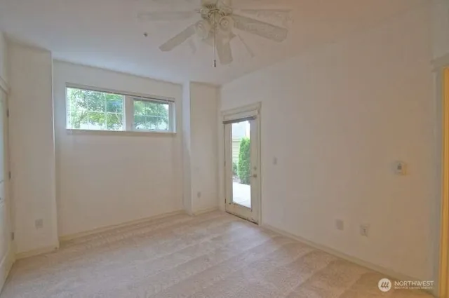 an empty room with windows and entrance