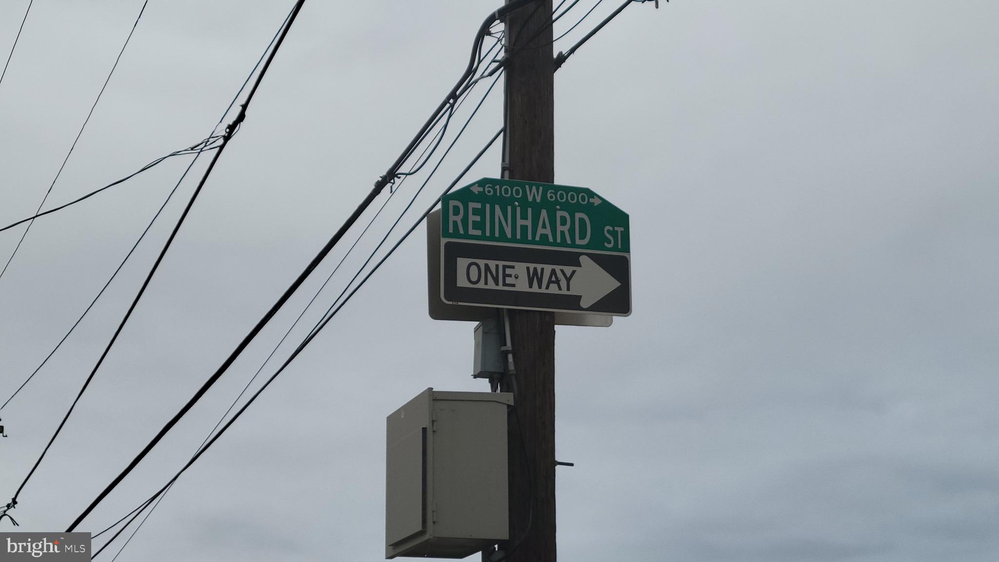 6089 Reinhard Street Philadelphia, PA 19142 - Photo 3 of 9 a street sign on a metal railing and two windows