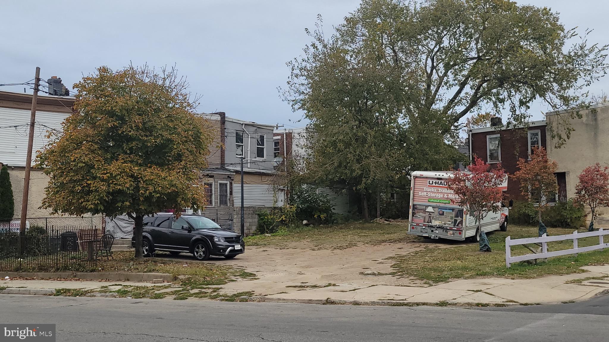 6089 Reinhard Street Philadelphia, PA 19142 - Photo 4 of 9 a view of a house with a cars park next to a road