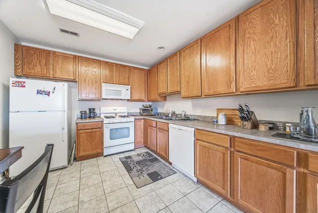 a kitchen with granite countertop appliances cabinets and a sink