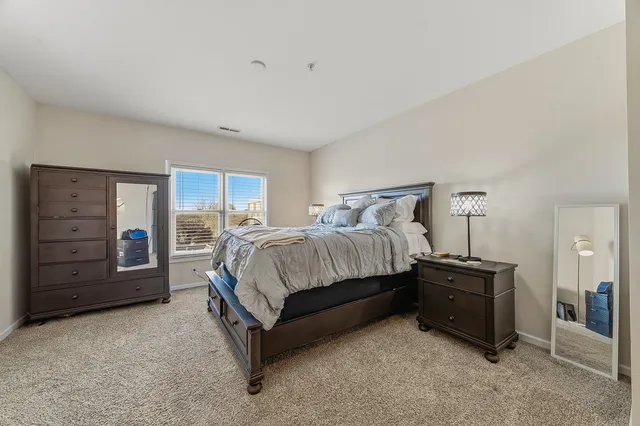 a bedroom with a bed and dresser