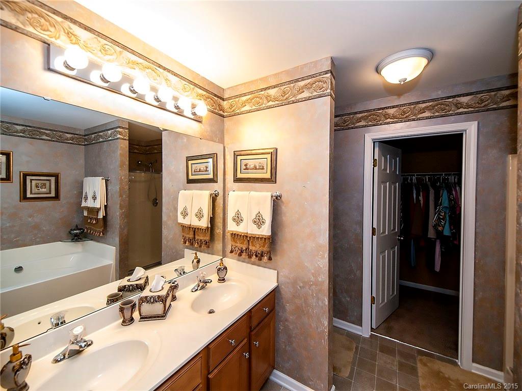 1907 Travertine Lane, Unit 209 Fort Mill, SC 29708 - Photo 11 of 18 a bathroom with a sink vanity granite tub and shower