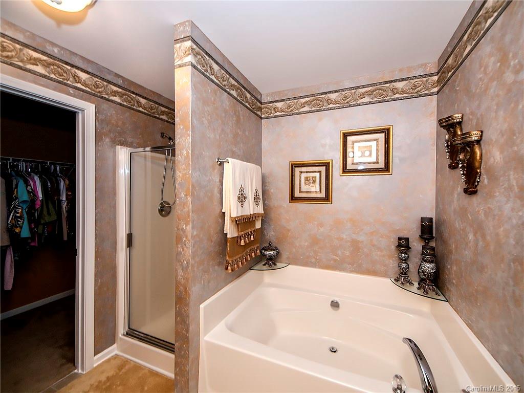 1907 Travertine Lane, Unit 209 Fort Mill, SC 29708 - Photo 12 of 18 a bathroom with a white bath tub and shower