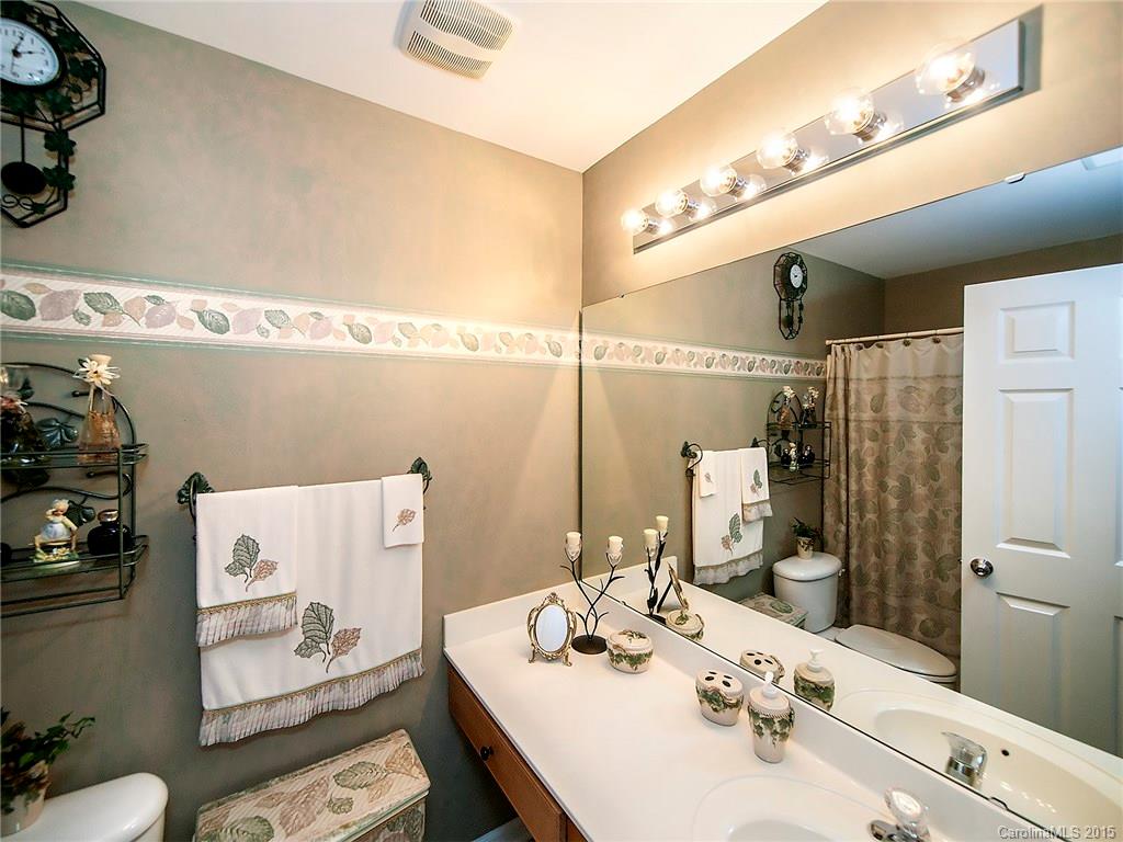 1907 Travertine Lane, Unit 209 Fort Mill, SC 29708 - Photo 14 of 18 a bathroom with a sink and a mirror