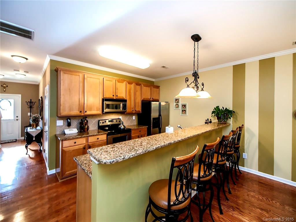 1907 Travertine Lane, Unit 209 Fort Mill, SC 29708 - Photo 16 of 18 a view of a dining room and livingroom with furniture wooden floor a chandelier
