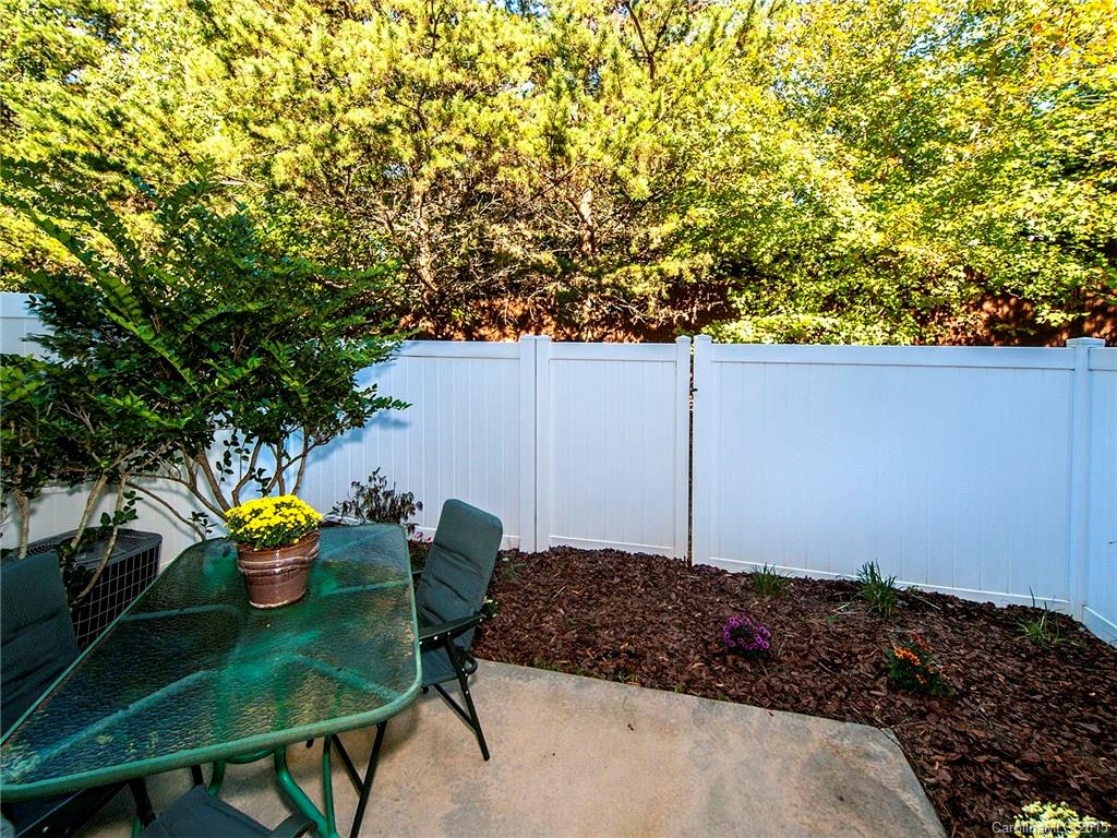 1907 Travertine Lane, Unit 209 Fort Mill, SC 29708 - Photo 18 of 18 a backyard of a house with table and chairs