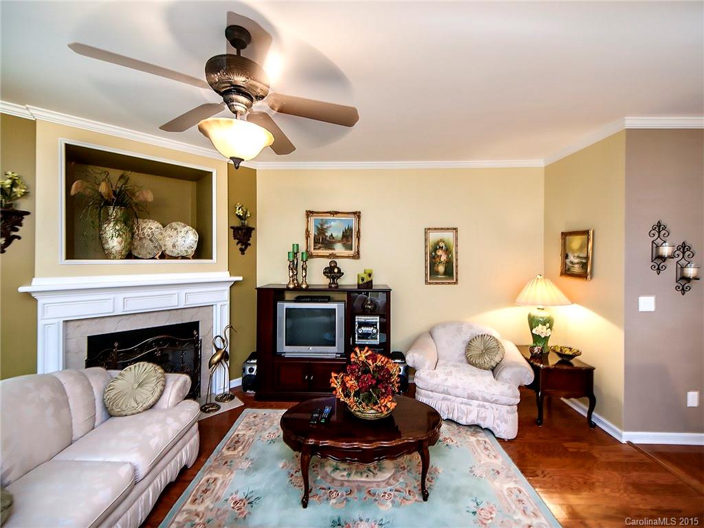 1907 Travertine Lane, Unit 209 Fort Mill, SC 29708 - Photo 3 of 18 a living room with furniture a flat screen tv and a fireplace