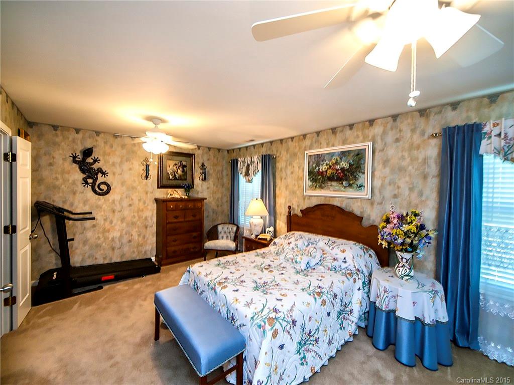 1907 Travertine Lane, Unit 209 Fort Mill, SC 29708 - Photo 9 of 18 a bedroom with a bed and wooden floor