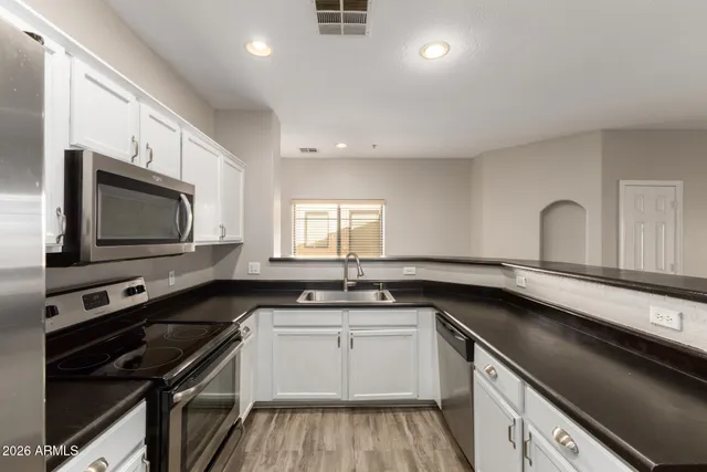 a kitchen with a sink stove and microwave