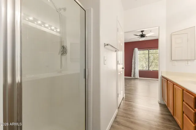 a view of a hallway with wooden floor and staircase