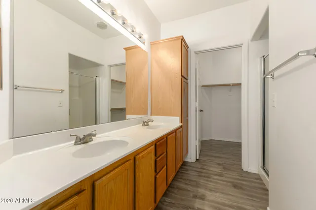 a bathroom with a double vanity sink and a mirror