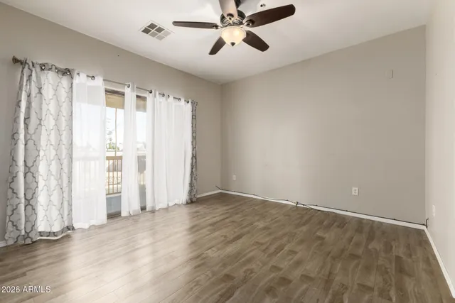 wooden floor in an empty room with a window
