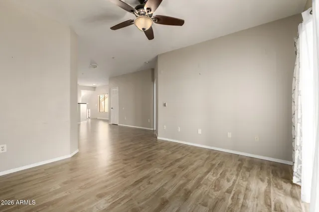 a view of a room with wooden floor and a window