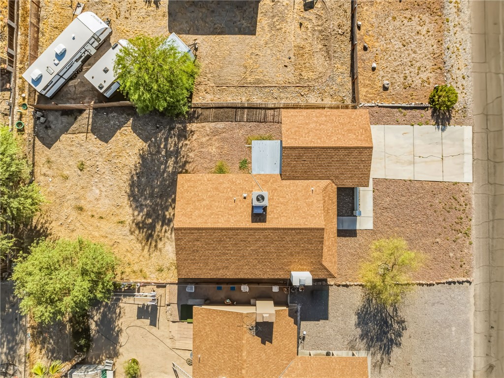 1720 Valencia Road Fort Mohave, AZ 86426 - Photo 2 of 32 Expansive property featuring a brown shingle roof, mature trees, and a concrete pad
