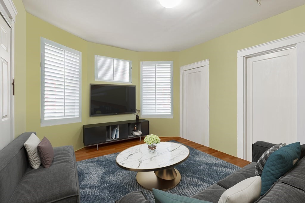 7 Vassar Street Boston, MA 02121 - Photo 2 of 8 a living room with furniture and a flat screen tv