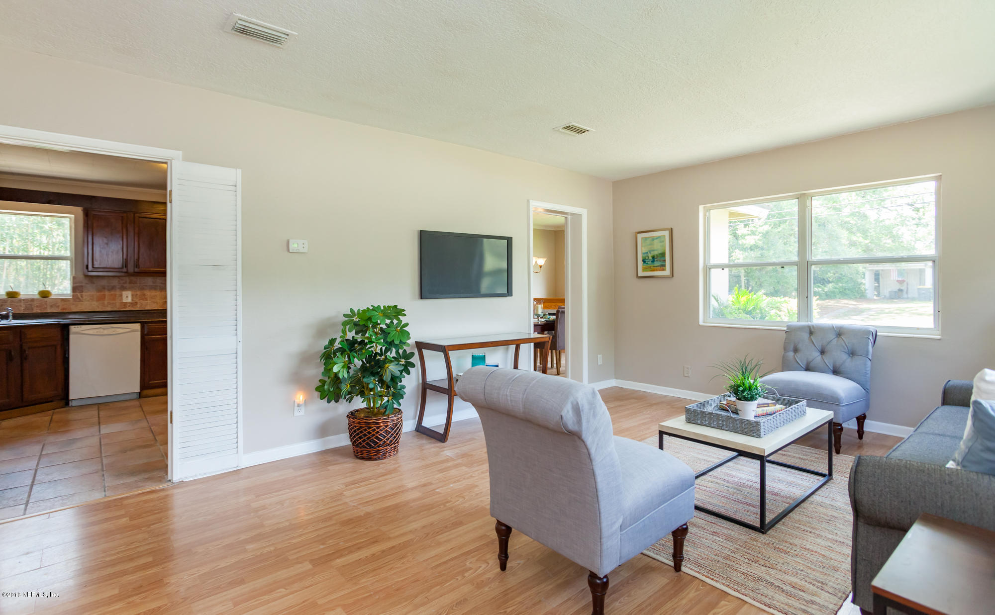 2606 Clemson Road Jacksonville, FL 32217 - Photo 6 of 25 a living room with furniture potted plant and window