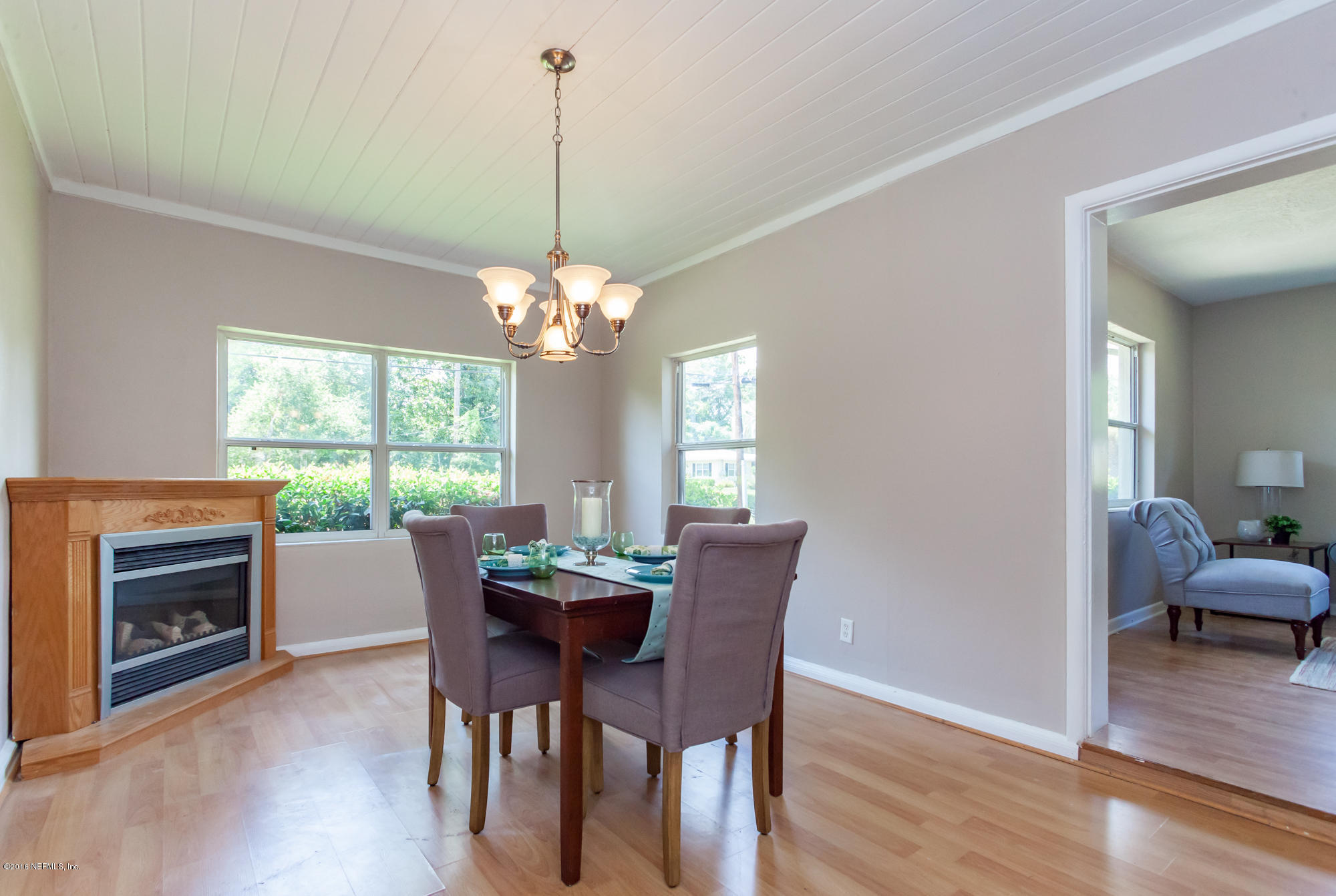 2606 Clemson Road Jacksonville, FL 32217 - Photo 10 of 25 a view of a dining room with furniture a chandelier and wooden floor